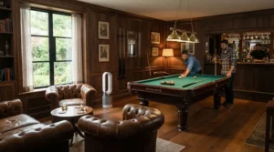 An air purifier for finished basement running quietly in a stylish man cave with a pool table and bar.